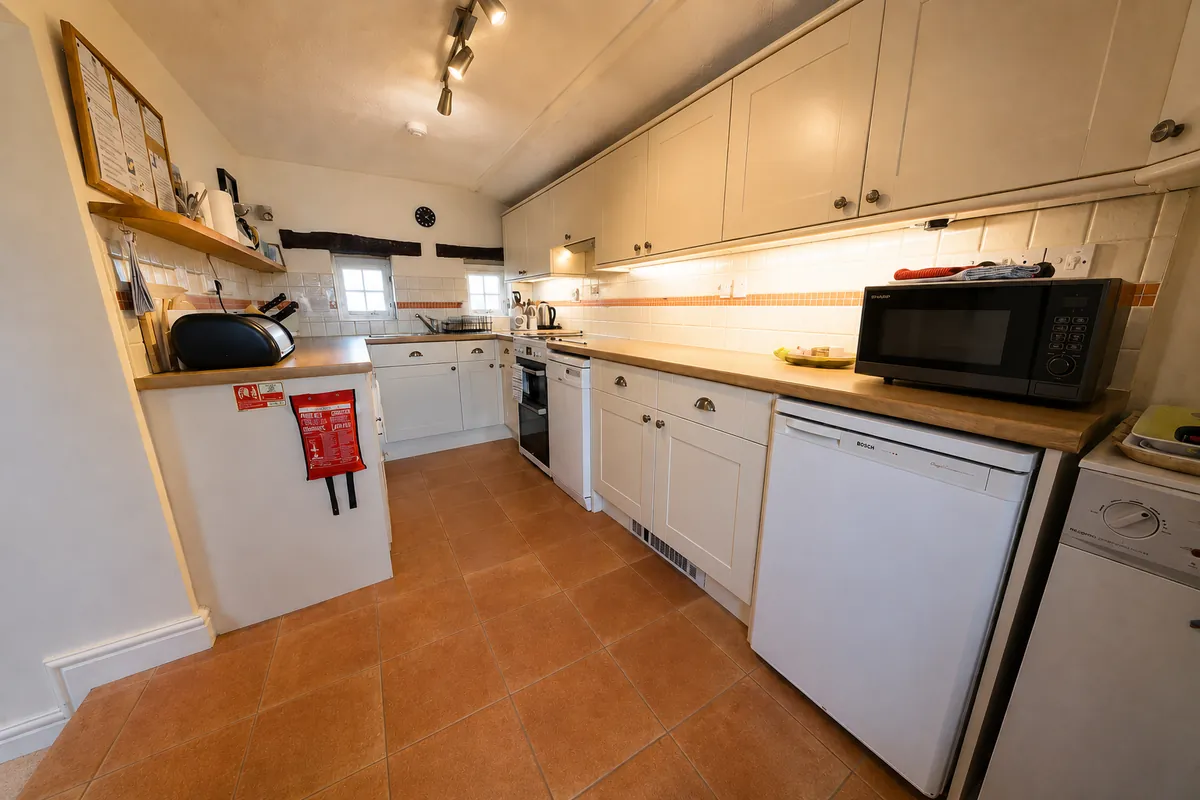 Galley kitchen with electric oven, hob, microwave and dishwasher